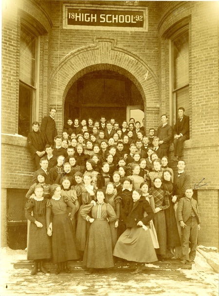 School photo at 1892 school building showing approximately 100 students