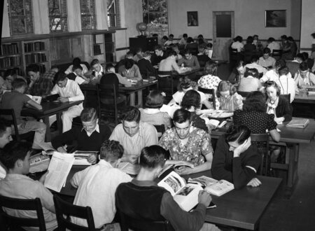 Students reading in a classroom, possibly an industrial arts class