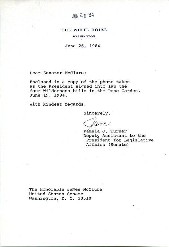Letter in which White House staffer Pamela J. Turner provides details to Senator James A. McClure about an enclosed photograph of McClure and others observing a bill signing by President Ronald Reagan in the White House Rose Garden.