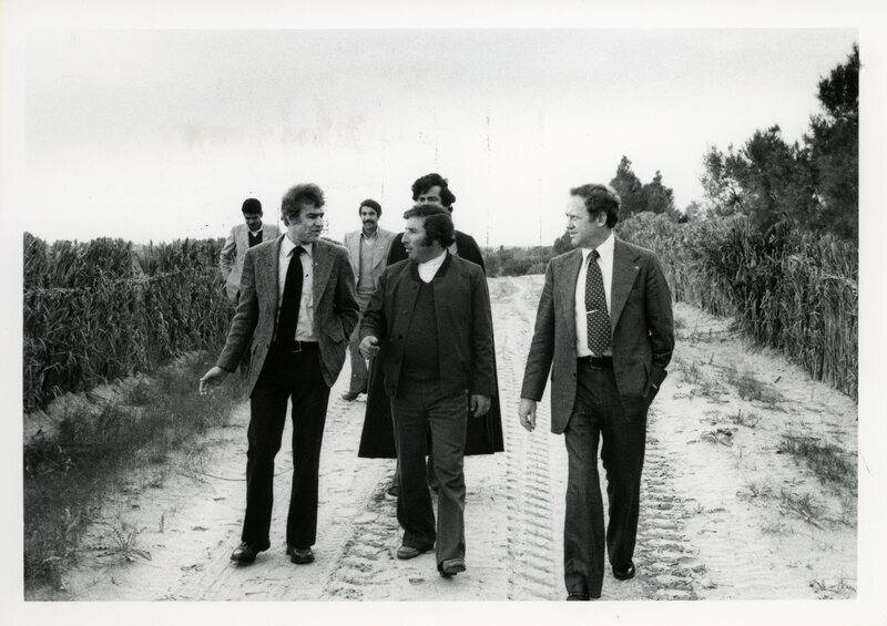 Senator James A. McClure and unknown others walk on a road in Libya.