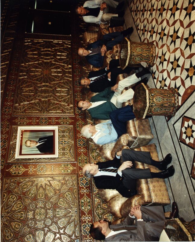 Senator James A. McClure, second from left, sits with others in a meeting in Syria.