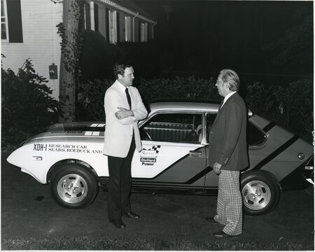Senator James A. McClure stands with an unknown person next to a car labeled XDH-1 Research Car Sears, Roebuck and Co.