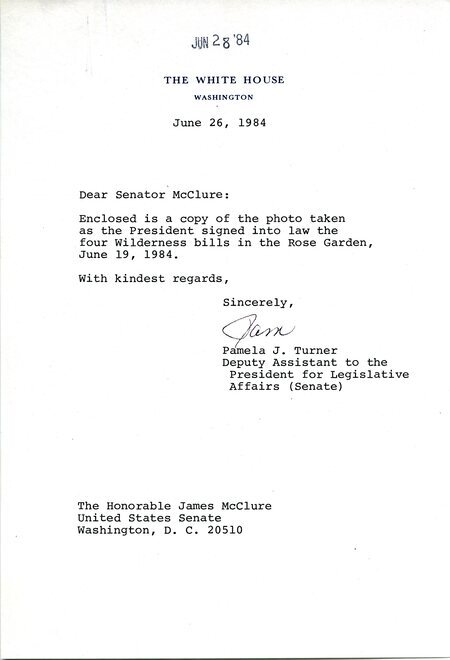 Letter in which White House staffer Pamela J. Turner provides details to Senator James A. McClure about an enclosed photograph of McClure and others observing a bill signing by President Ronald Reagan in the White House Rose Garden.