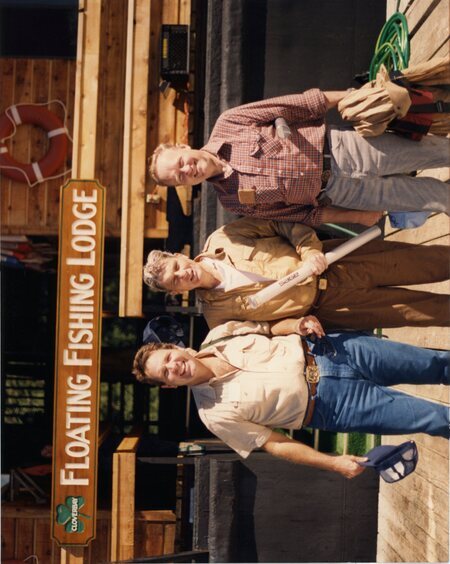 Senator James A. McClure stands with Senator Steven D. Symms and Senator John Warner at the Clover Bay Floating Fishing Lodge.