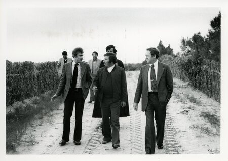 Senator James A. McClure and unknown others walk on a road in Libya.