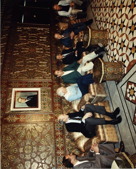 Senator James A. McClure, second from left, sits with others in a meeting in Syria.