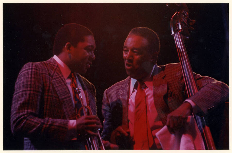 10" x 8" color photograph. Wynton Marsalis and Ray Brown talk on stage at the 1989 Lionel Hampton-Chevron Jazz Festival.