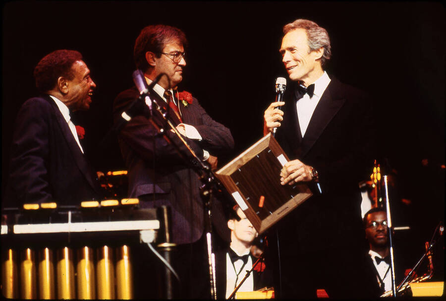 35mm color slide. Clint Eastwood receiving the Lionel Hampton Jazz Hall of Fame award. He is on stage with Lionel Hampton and Lynn "Doc" Skinner.
