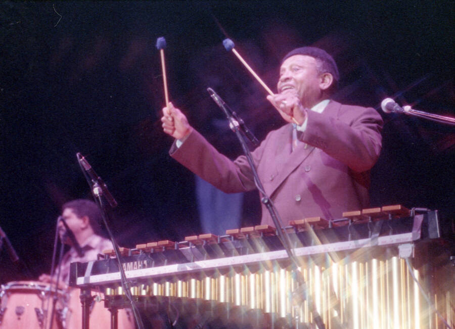 35mm color negative. Lionel Hampton playing the vibes with Gabriel Machado playing conga in the background at the 1991 Lionel Hampton-Chevron Jazz Festival.