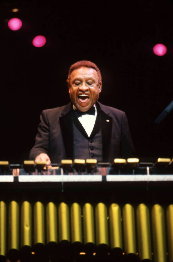 35 mm color slide. Lionel Hampton stands in front of his vibes smiling.