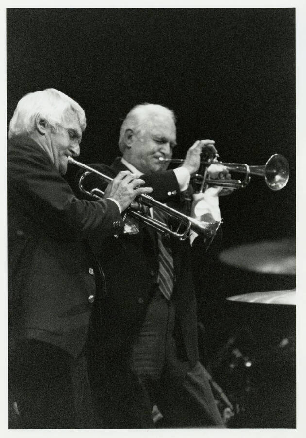 5" x 7" black and white photograph. Pete and Conte Candoli play their trumpets at the Lionel Hampton Jazz Festival.