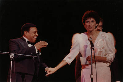 12" x 8" color photograph. Lionel Hampton and President Zinser on stage at the jazz festival. Lynn "Doc" Skinner stands in the background.