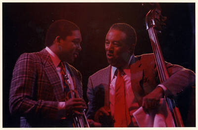10" x 8" color photograph. Wynton Marsalis and Ray Brown talk on stage at the 1989 Lionel Hampton-Chevron Jazz Festival.