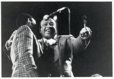 10" x 8" black and white photograph. Lionel Hampton hugging Wynton Marsalis on stage at the 1989 Lionel Hampton-Chevron Jazz Festival.