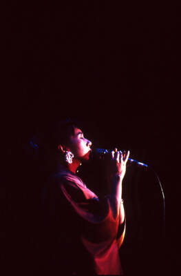 35 mm color slide. Reiko Aoki sings at the Pepsi International World Jazz Night at the 1992 Lionel Hampton-Chevron Jazz Festival wearing a kimono.