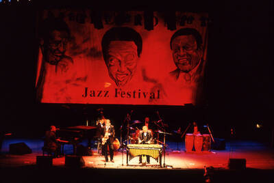 35 mm color slide. Lionel Hampton, Lembit Saarsalu, Leon Dorsey, Wally "Gator" Watson, Gabriel Machado, and Leonid Vintskevich perform at the Pepsi International World Jazz Night at the 1992 Lionel Hampton-Chevron Jazz Festival evening concert.