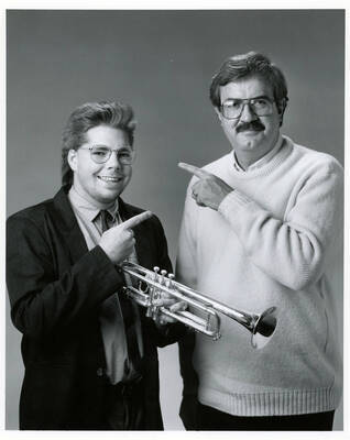 8" x 10" black and white photograph. Lynn "Doc" Skinner with John Fricke pointing at each other.