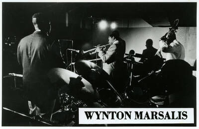 6.5" x 4" black and white photograph. Wynton Marsalis performing with a band. Likely a promotional photograph used by Marsalis.