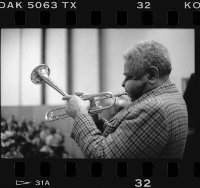 1.5" x 1" black and white print. One of thirty images found on a contact sheet. Dizzy Gillespie playing trumpet during his jazz clinic.