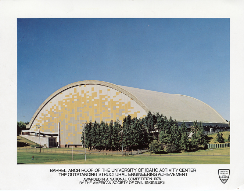Color photograph of a building with an arched roof and gray and yellow decorations on the end wall. Text below the image reads: "Barrel Arch Roof of the University of Idaho Activity Center The Outstanding Structural Engineering Achievement Awarded in a National Competition 1976 by the American Society of Civil Engineers"