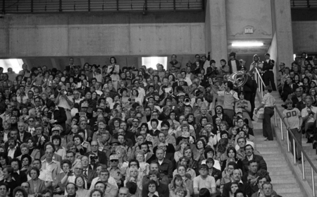 Black and white photographs of spectators sitting in stands.