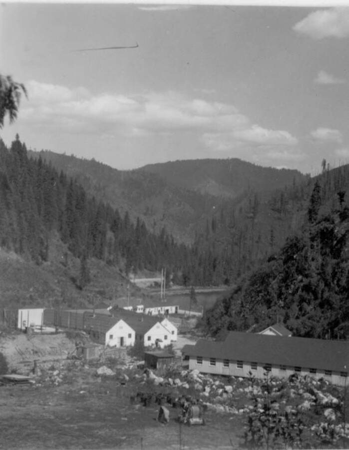 Image of buildings at Kooskia Internment Camp with the Lochsa Lochsa River in the background. Photo taken from 12-3/4 x 15-1/4 Photograph album of the Kooskia Japanese Internment Camp.