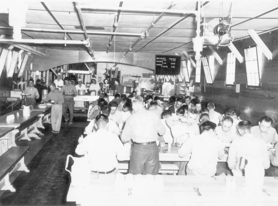 Interior shot of men eating in cafeteria at Kooskia Internment Camp. Photo taken from 12-3/4 x 15-1/4 Photograph album of the Kooskia Japanese Internment Camp.