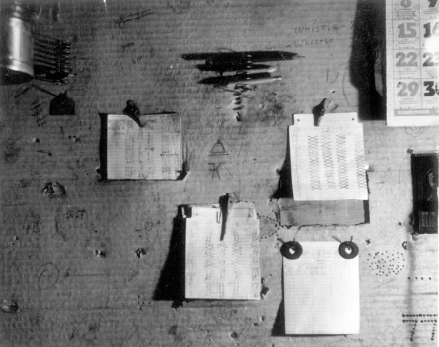 Image of  bulletin board. Photo taken from 12-3/4 x 15-1/4 Photograph album of the Kooskia Japanese Internment Camp.