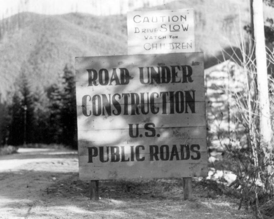 Image of "Road Under Construction" sign at Kooskia Internment Camp. Photo taken from 12-3/4 x 15-1/4 Photograph album of the Kooskia Japanese Internment Camp.