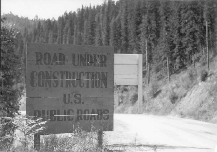 Image of "Road Under Construction" sign by Kooskia Internment Camp. Photo taken from 12-3/4 x 15-1/4 Photograph album of the Kooskia Japanese Internment Camp.