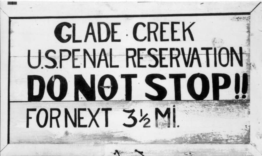 Image of sign reading "Glade Creek U.S. Penal Reservation" at Kooskia Internment Camp. Photo taken from 12-3/4 x 15-1/4 Photograph album of the Kooskia Japanese Internment Camp.