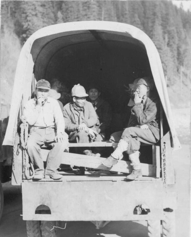 Image of people in back of vehicle at Kooskia Internment Camp. Photo taken from 12-3/4 x 15-1/4 Photograph album of the Kooskia Japanese Internment Camp.