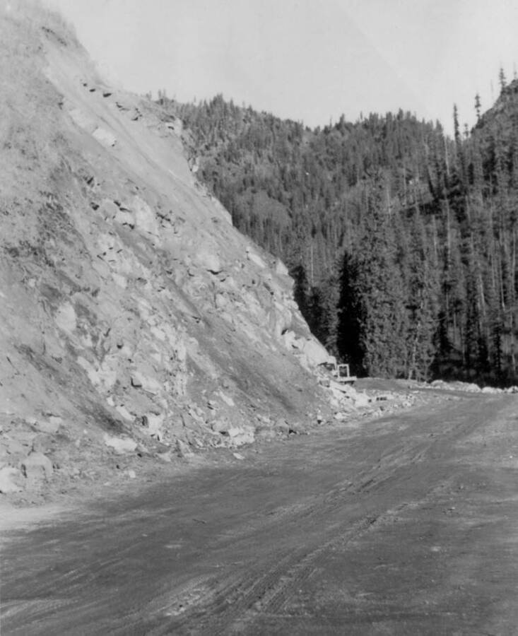 Image of dirt road and construction equipment at Kooskia Internment Camp. Photo taken from 12-3/4 x 15-1/4 Photograph album of the Kooskia Japanese Internment Camp.