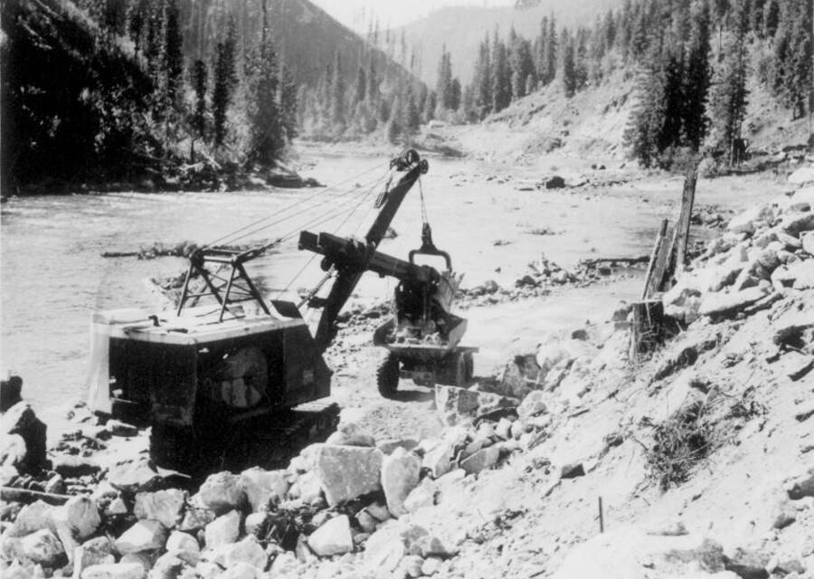 Image of construction machinery in front of Lochsa River at Kooskia Internment Camp. Photo taken from 12-3/4 x 15-1/4 Photograph album of the Kooskia Japanese Internment Camp.