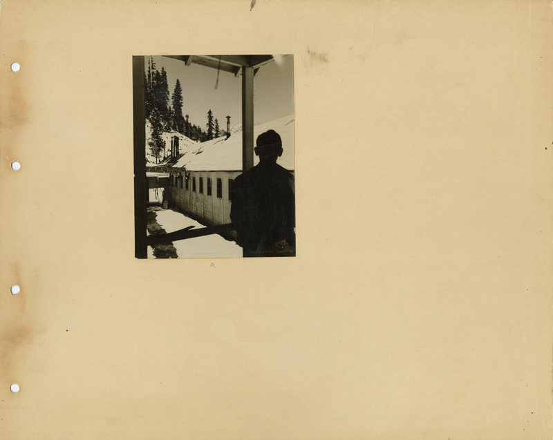 Image of a page of the scrapbook. The page is lightly tinted from age. Includes one photo in the upper middle, slightly to the left.