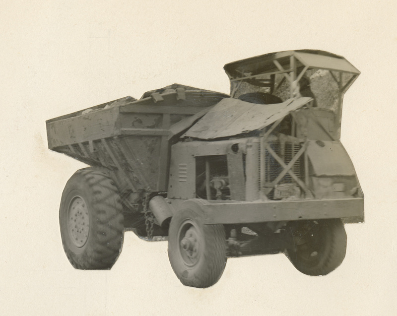 A black and white cutout photograph of a large piece of construction equipment.