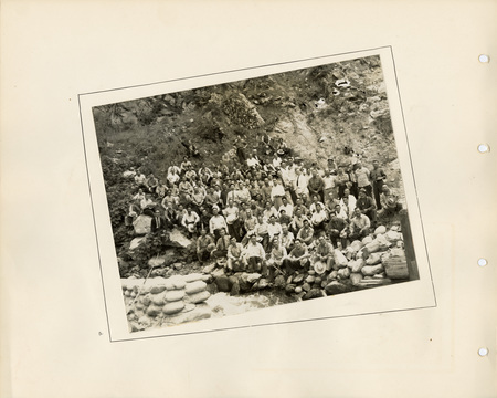 Image of a page from the scrapbook. The page is lightly tinted due to age and includes one black and white photo in the center.
