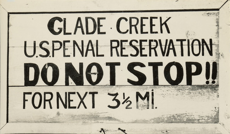 A black and white image of a sign. It reads "Glade Creek U.S. Penal Reservation. DO NOT STOP!! For next 3 1/2 miles". 