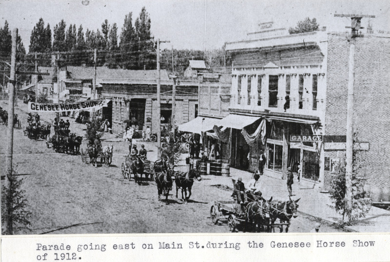 Parade going east on Main Street in Genesee. In this image, the Vollmer Building is the first building on the right.