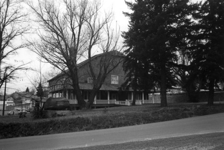 Image of the Gymnasium with grown trees and the William Deary memorial monument.