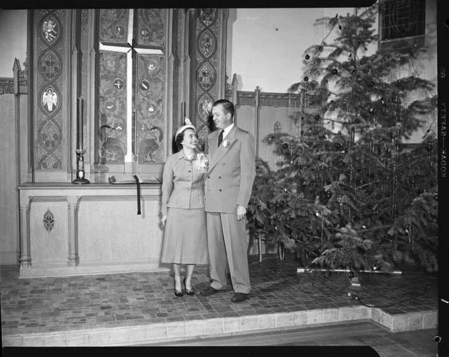 Image shows Don Wilson and his bride on their wedding day in a church around Christmas time.