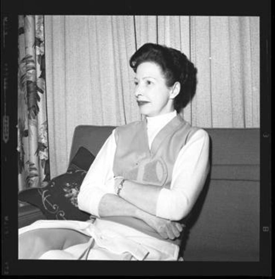 Woman dressed in costume sitting on sofa.