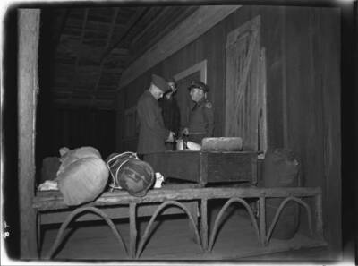 Men inside a building on a National Guard trip.