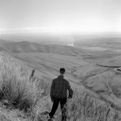 Image of man standing in front of unidentified valley.