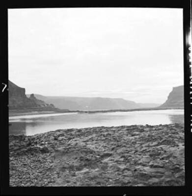 Shows Wallula Gap and in the foreground rocks on the right bank of the Walla Walla River