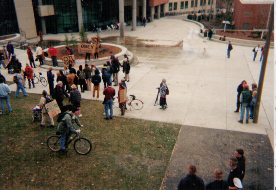 Groups of protesters gather in the mall outside of the University of Idaho Library for an anti-war rally in 1998