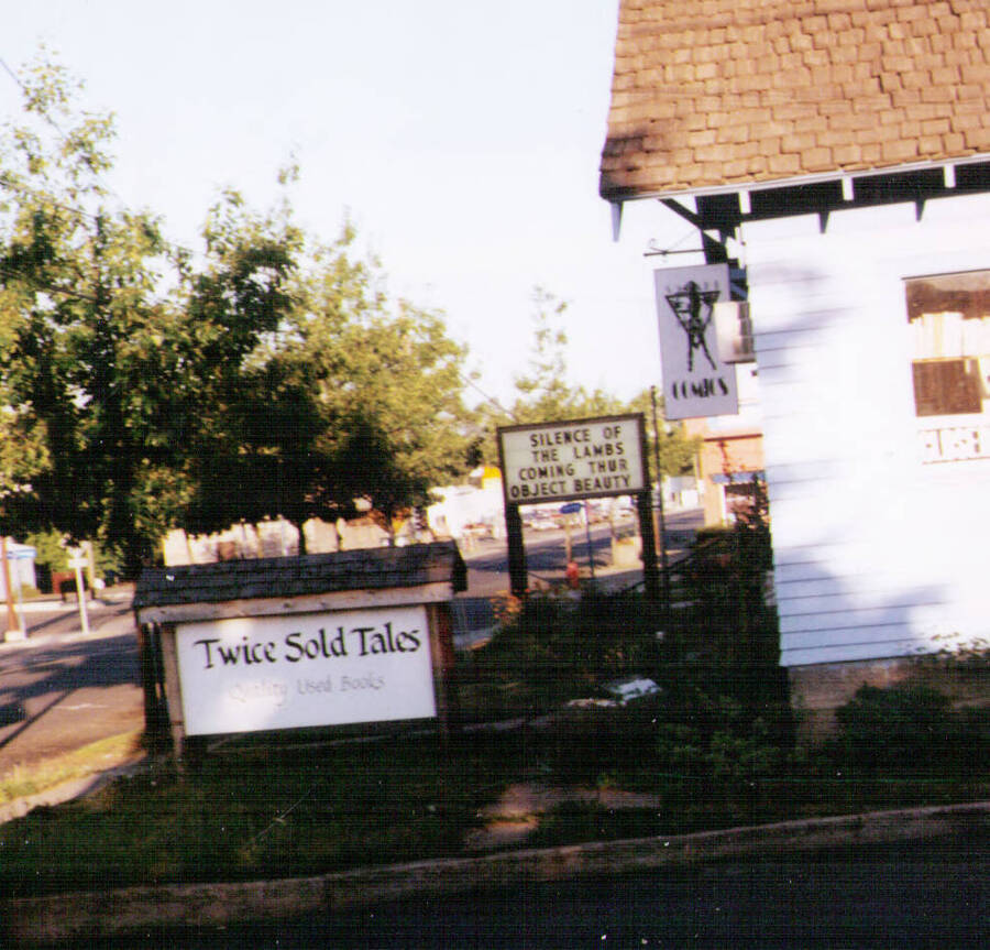 Twice Sold Tales, circa 1991, owned by Betty Smith & Eric Wegner. It is now Read It Again on Main Street owned by Scott Janke & Leah Evans-Janke. Also in the photograph is Safari Pearl at its original location, which was another comic shop before that. In the background is the marquee for the Micro Movie House.