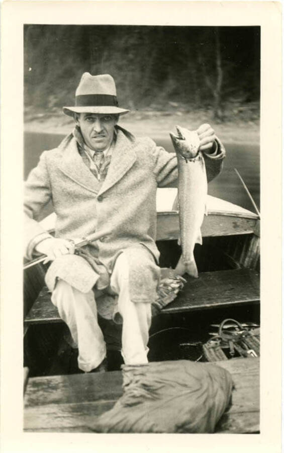 Bert Hopkins with fish on Lake Pend Oreille. Fish was 5 and half pounds and 24 inches, per back of photograph.