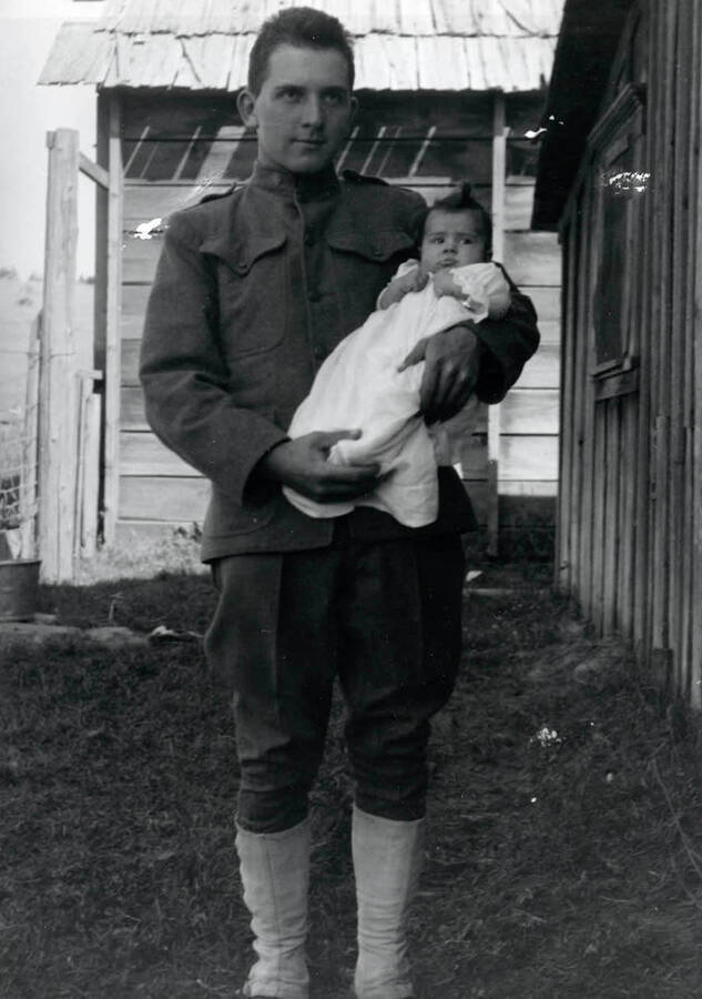 Durrell Nirk holding daughter Cleora Anna on his parents homestead.