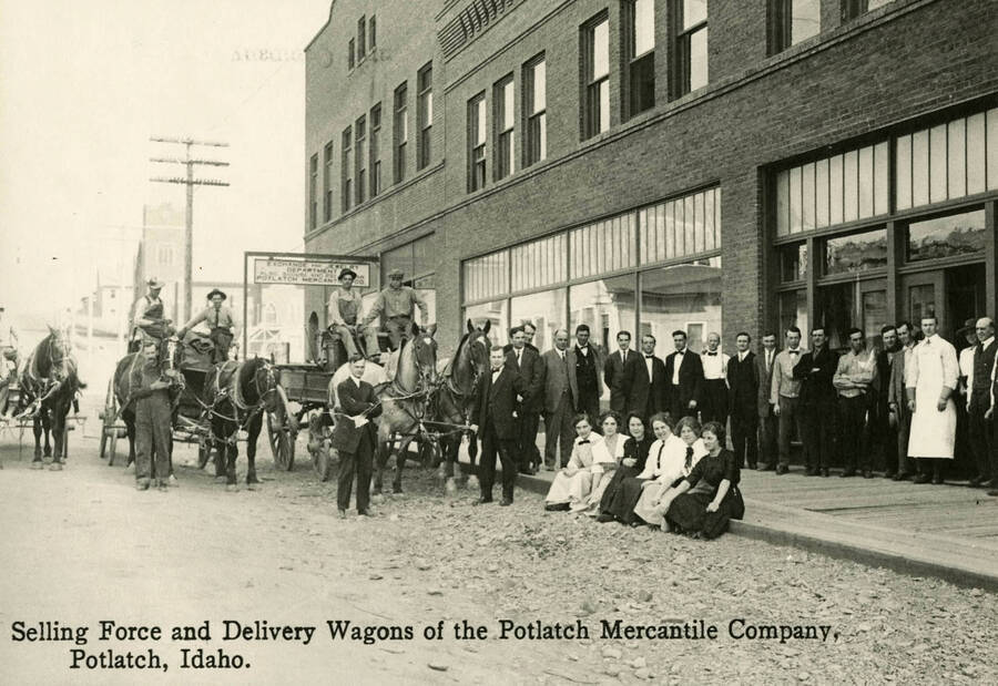 A group portrait of the selling force and delivery wagons of the Potlatch Mercantile Company in Potlatch, ID.